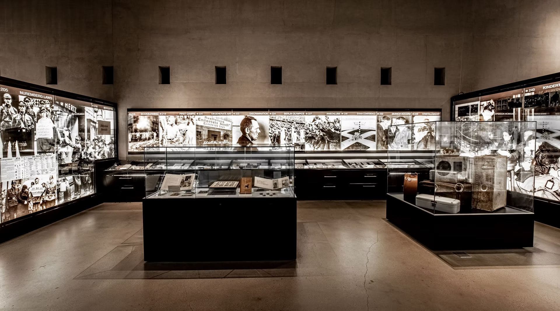 Permanent exhibition gallery with illuminated timeline panels and artifact cases