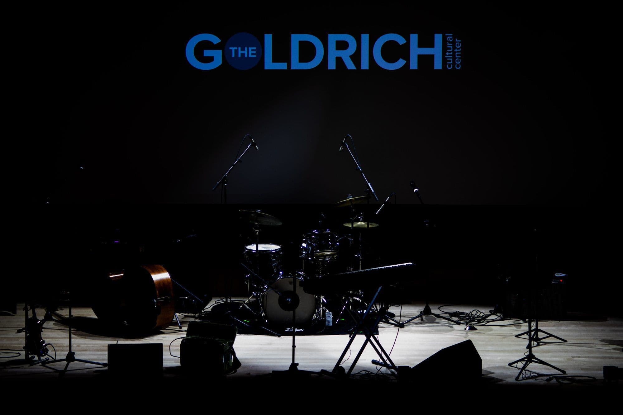 The S. Mark Taper Foundation Theater stage set for a concert, with The Goldrich logo projected above